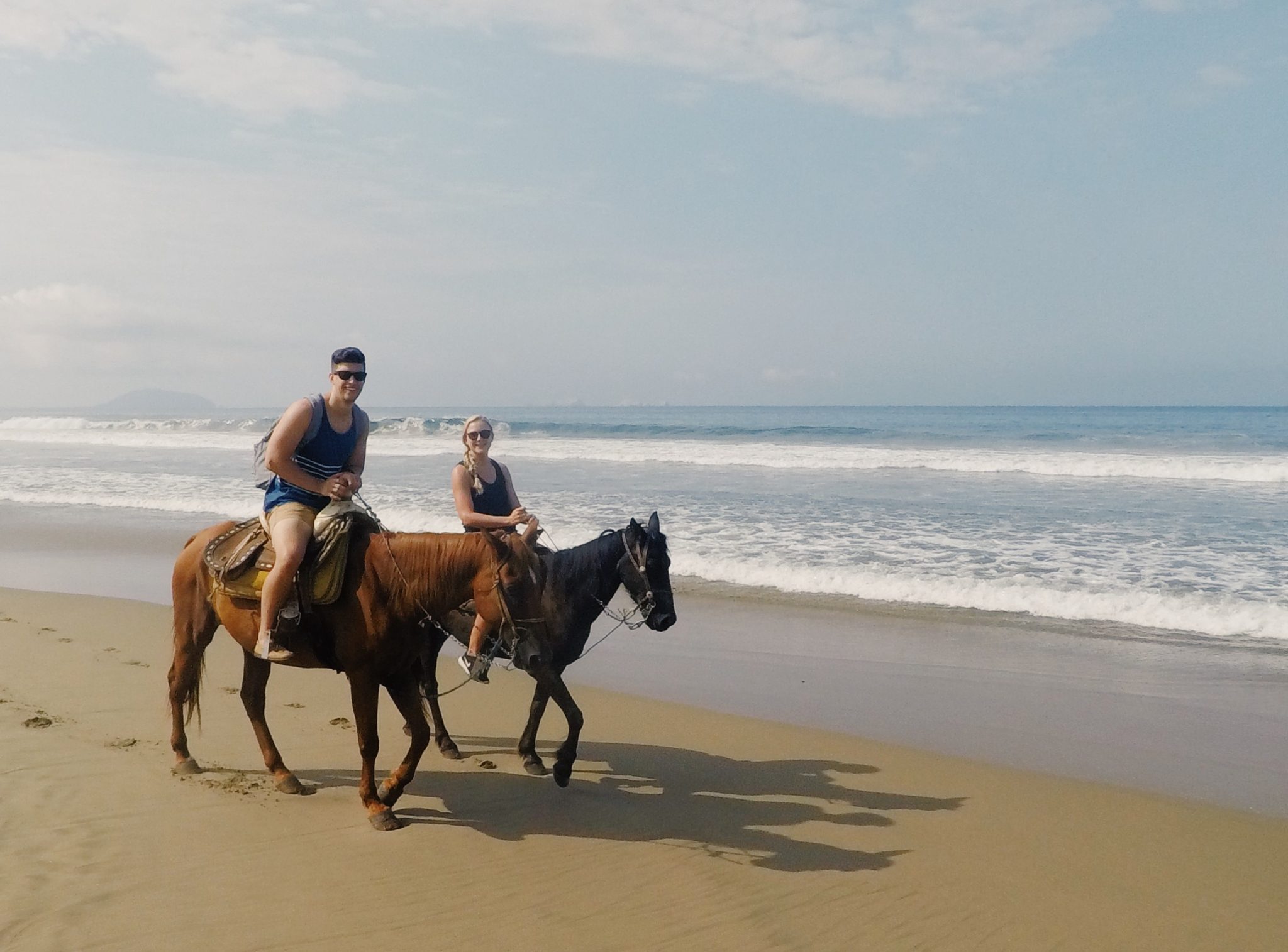 couple beach horseback riding in Zihuatanejo, Mexico