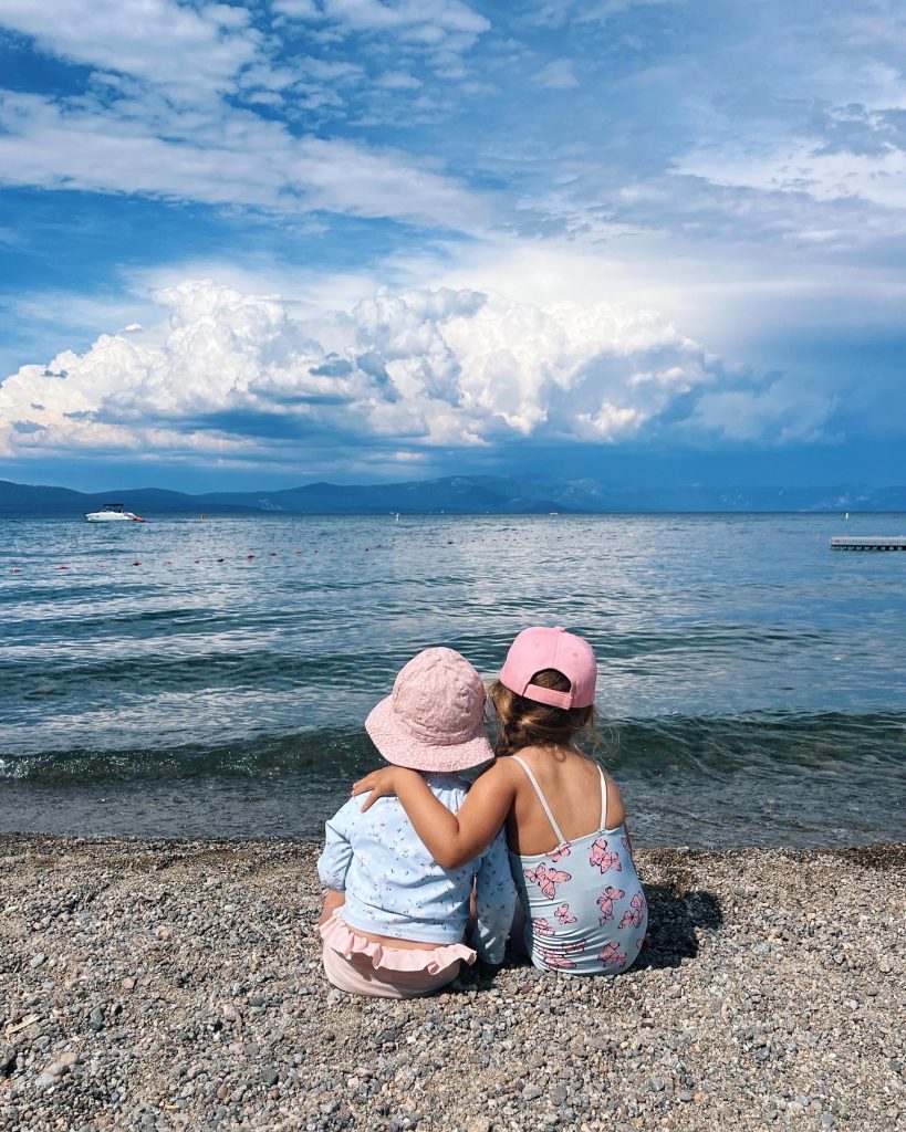two children sitting on a beach
