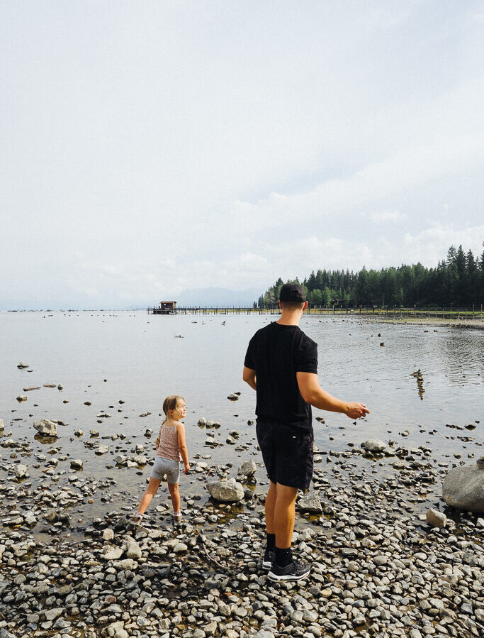 man and girl skipping rocks