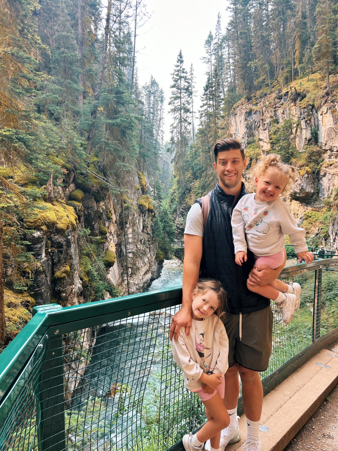 two kids with their dad hiking during a Banff Family Travel