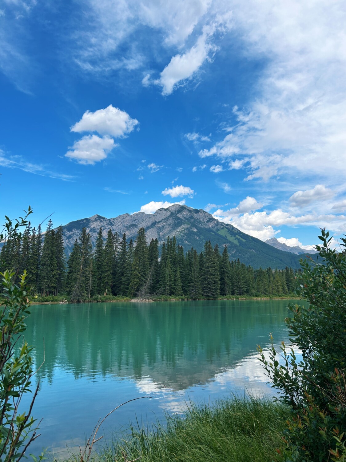 a view of the lake and mountain during a hike while in a Banff Family Travel