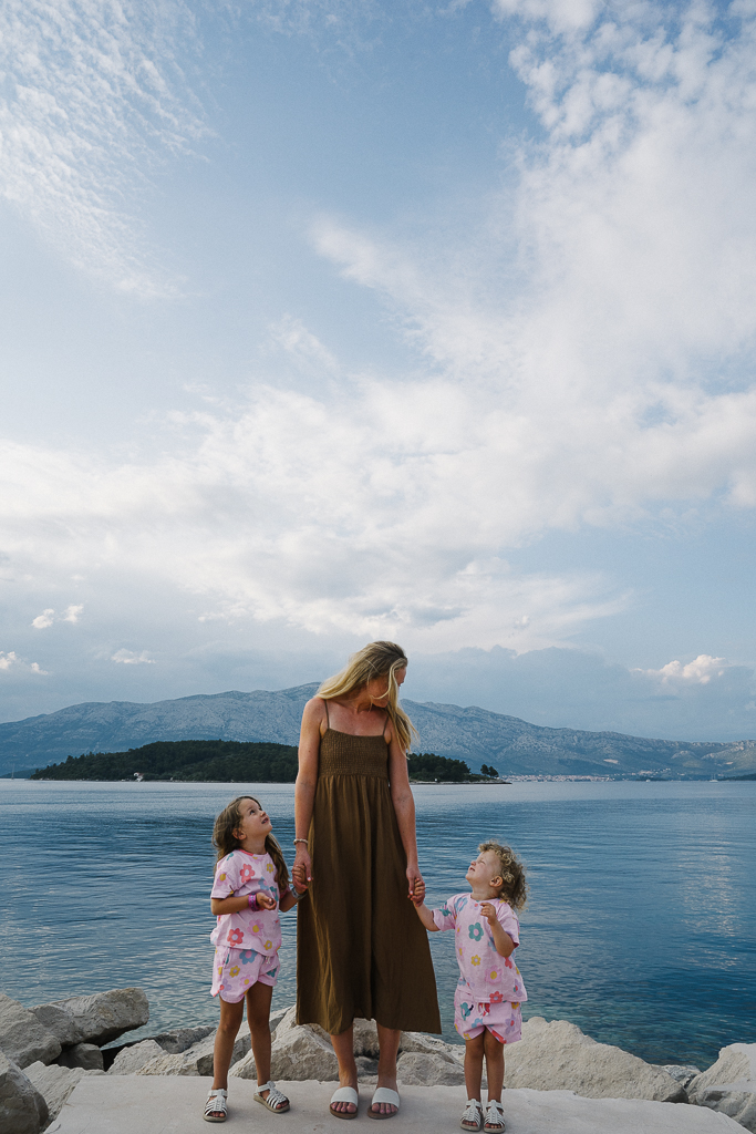 Ruth Nuss standing near the ocean sharing their Korcula Croatia Travel Guide