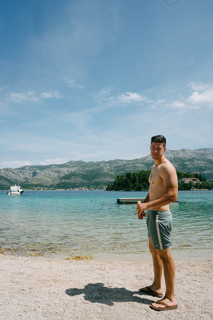 male standing near the beach sharing Korcula Croatia Travel Guide