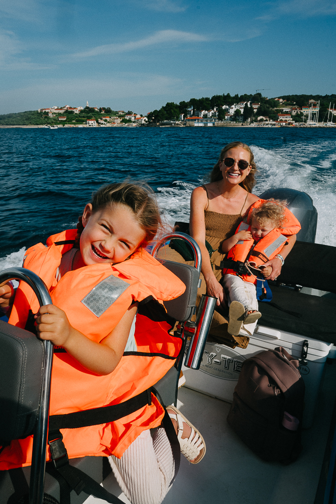 woman with her child two children in a boat ride sharing their Korcula Croatia Travel Guide