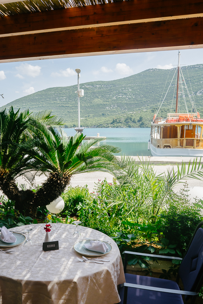a restaurant with a view of a docked boat 