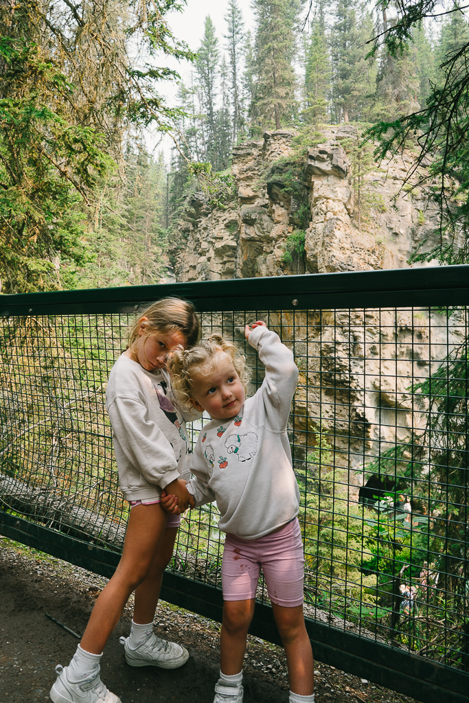 two kids on a bridge during a Banff Family Travel