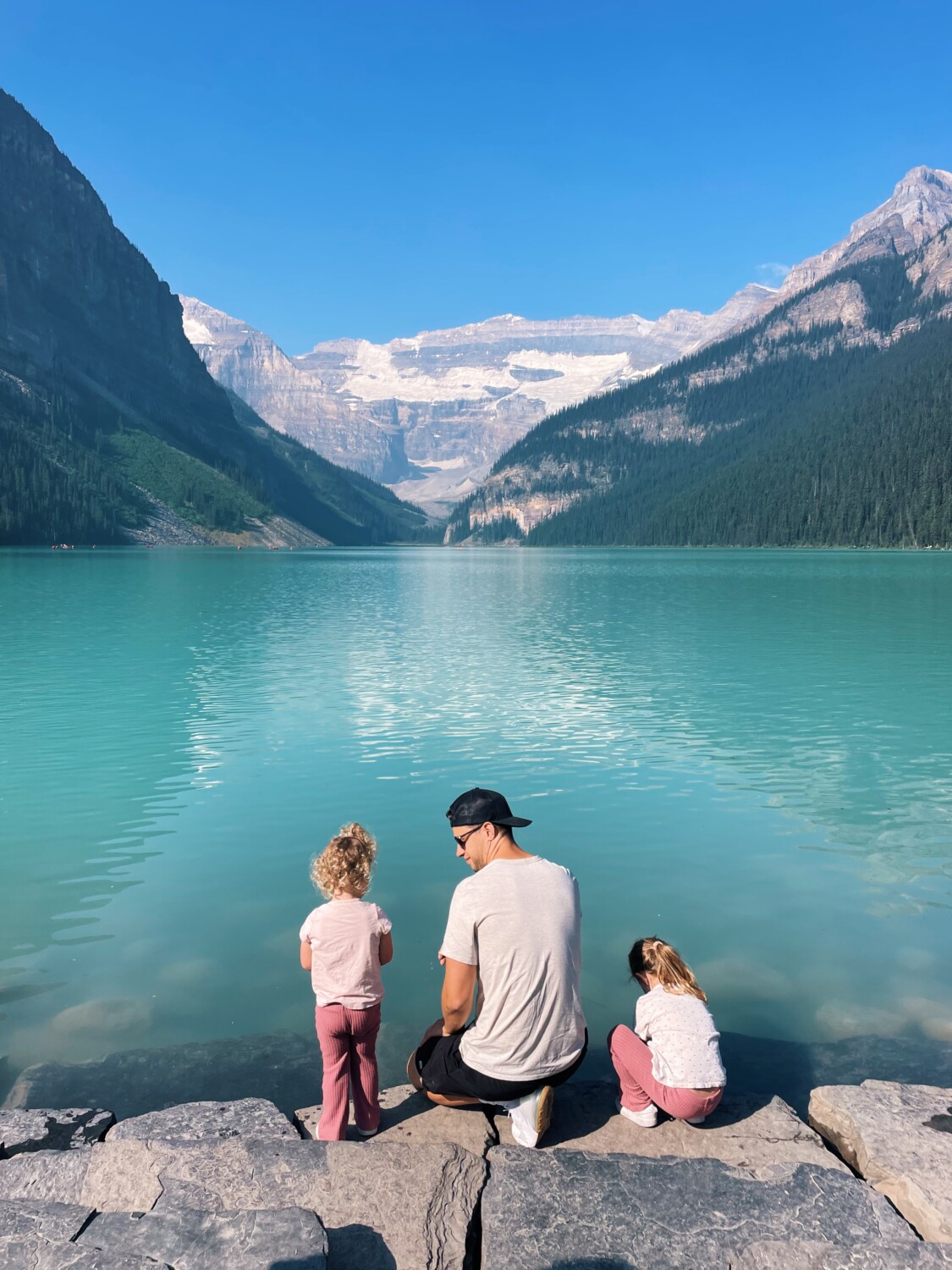 two kids with their dad sharing Banff Family Travel Guide