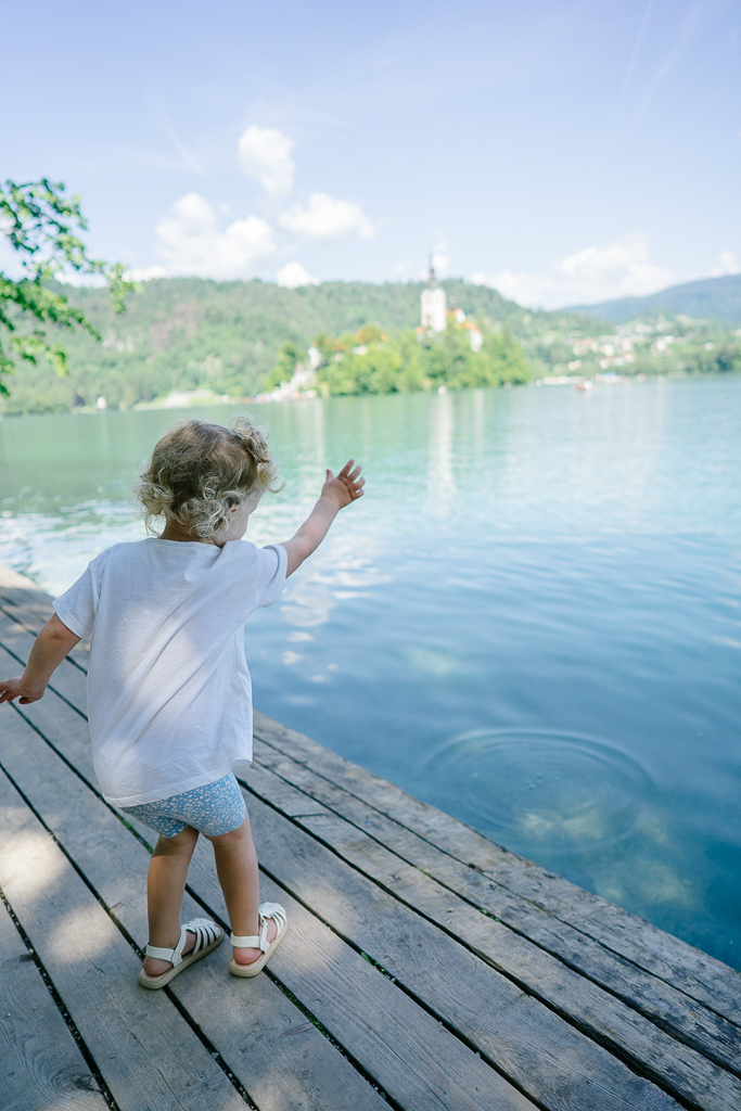 kid throwing rock at the lake