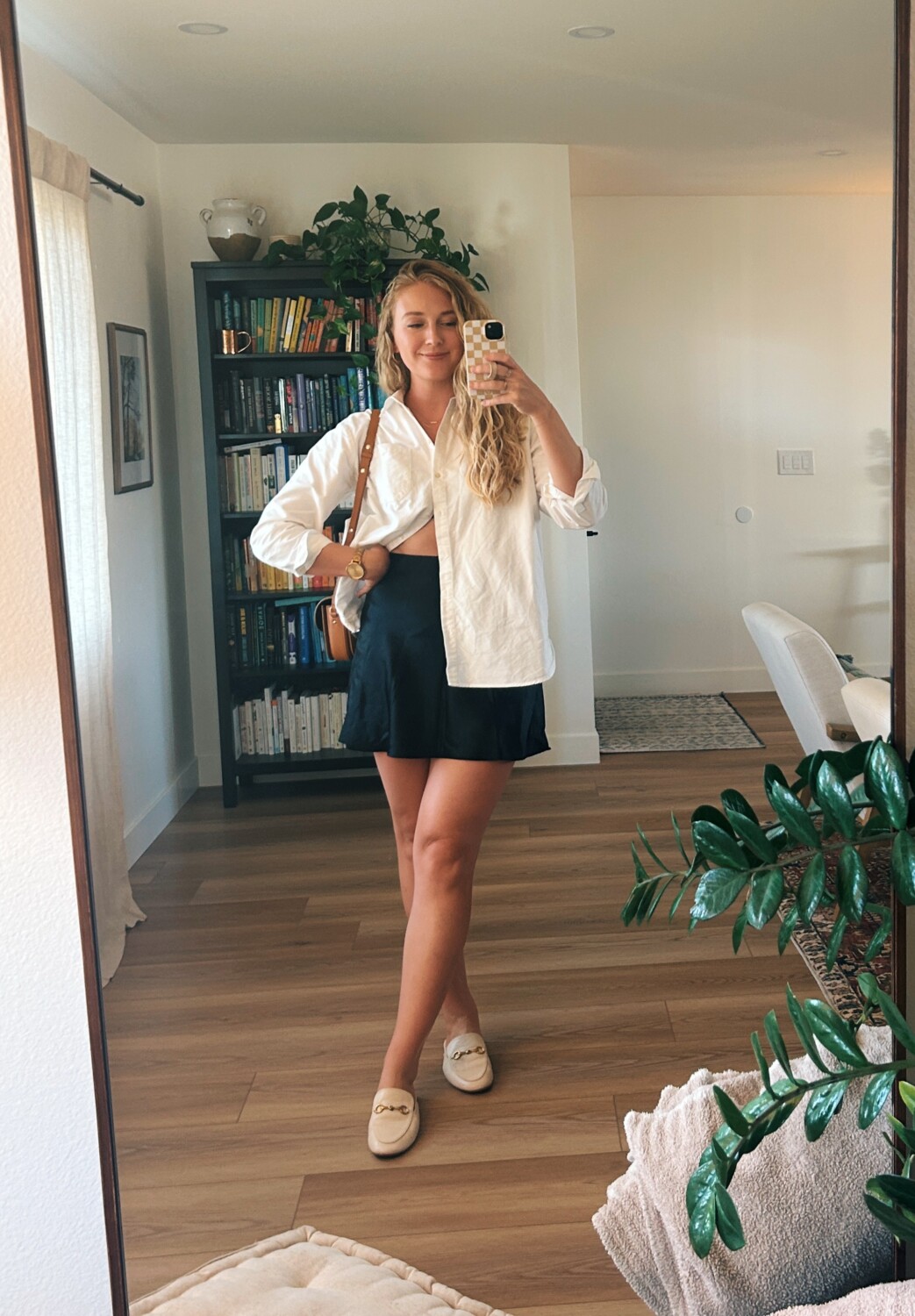 ruth nuss wearing a white button down shirt and black skirt for her sezane max shirt review