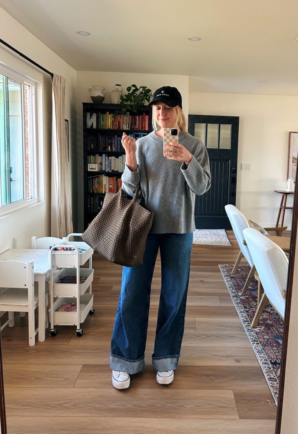 Ruth Nuss wearing a gray Quince cashmere sweater and a brown tote bag