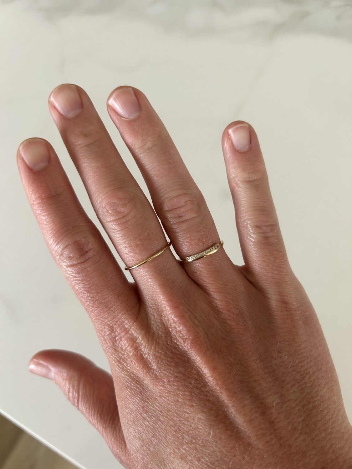 Woman's hand with two gold ringa
