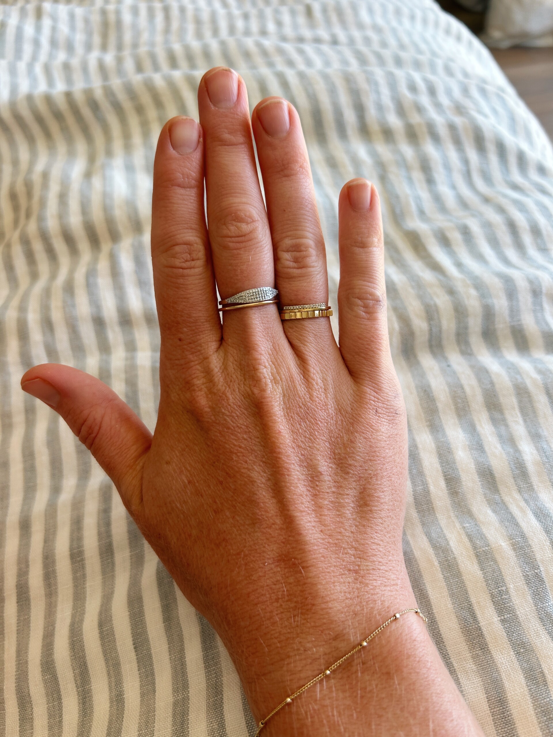 hand with 4 stacking rings from quince