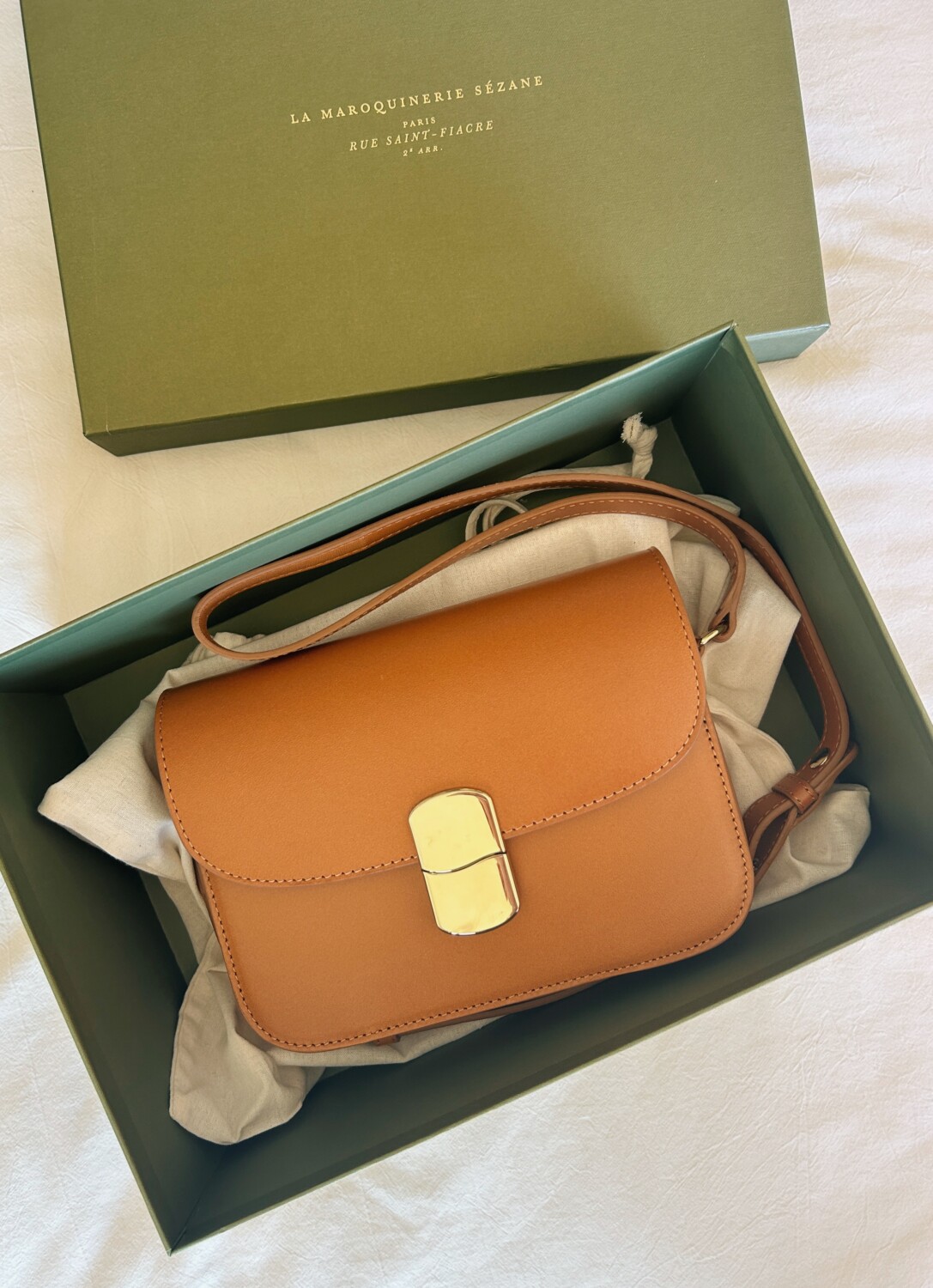 A Sézane Mini Milo Bag inside of its gift box