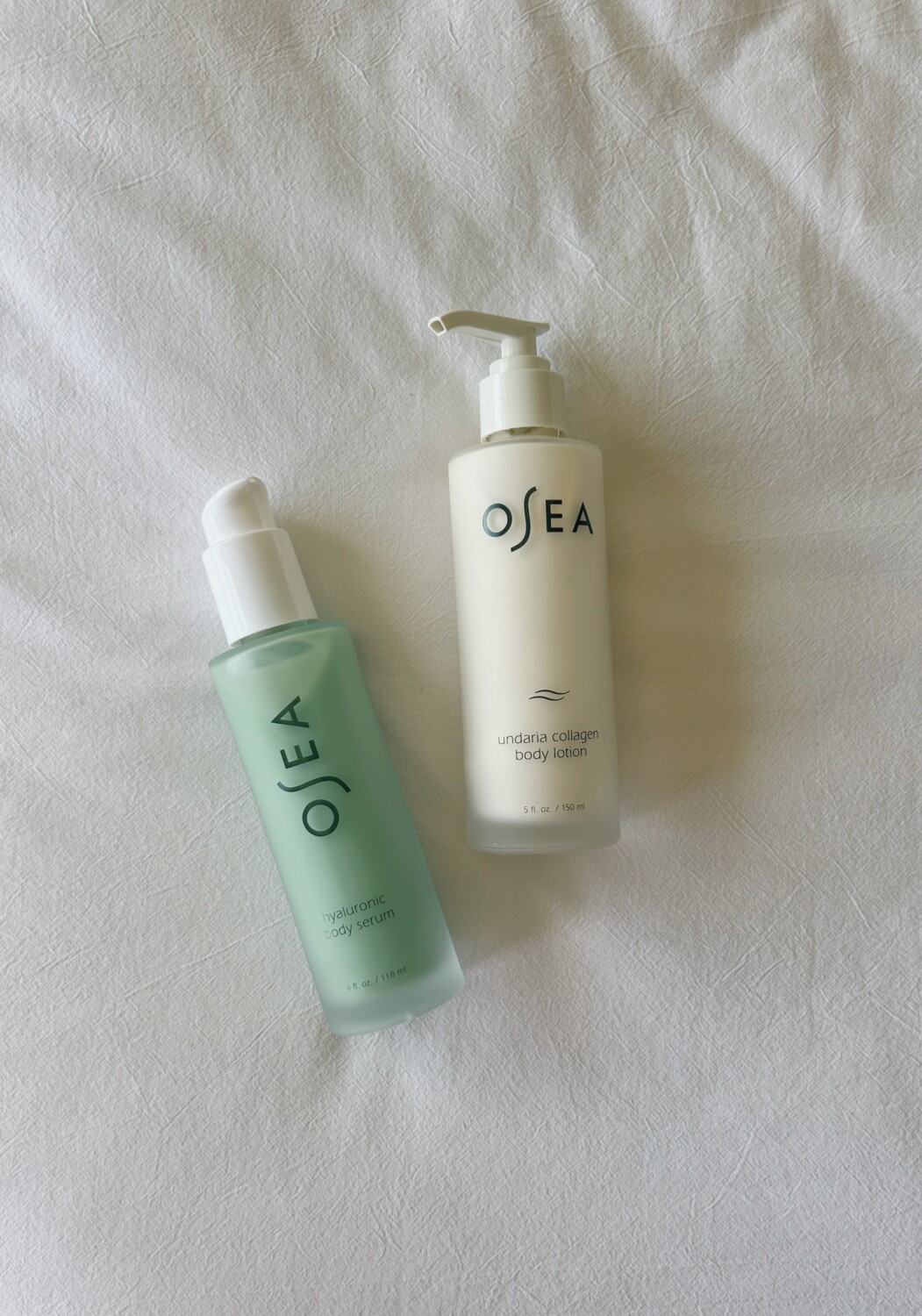 A bottle of Osea body serum and Osea collagen lotion