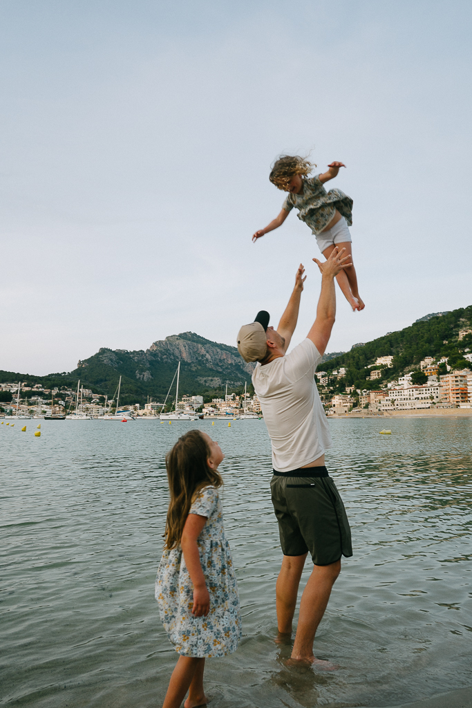 a family on the beach in port de soller 