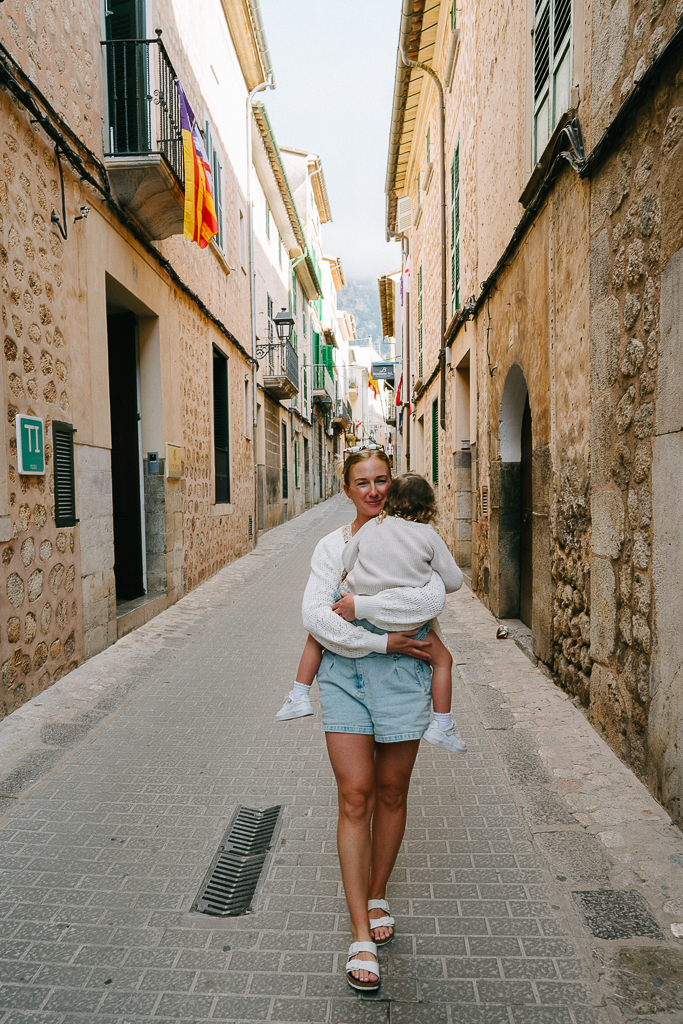 ruth nuss and her daughter walking on a street in soller mallorca spain