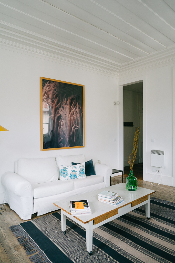 apartment with high celings, white couch, and striped rug on ruth nuss' 3 day lisbon itinerary
