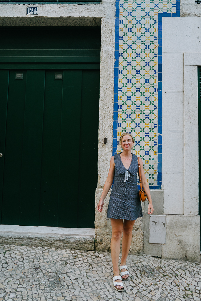 Ruth Nuss in a navy dress in the alfama district of lisbon