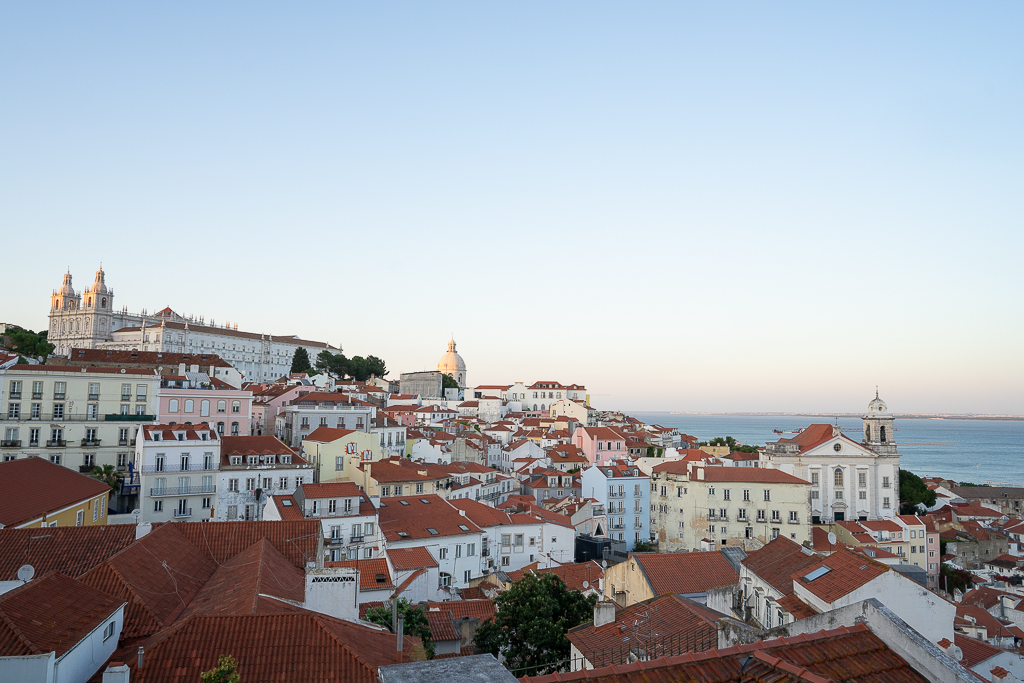 sunset over the alfama district in this 3 day lisbon itinerary
