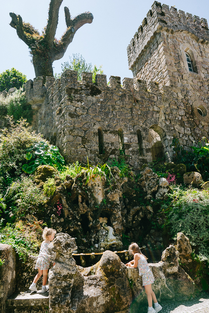 two girls at a well in quinta da regaleira