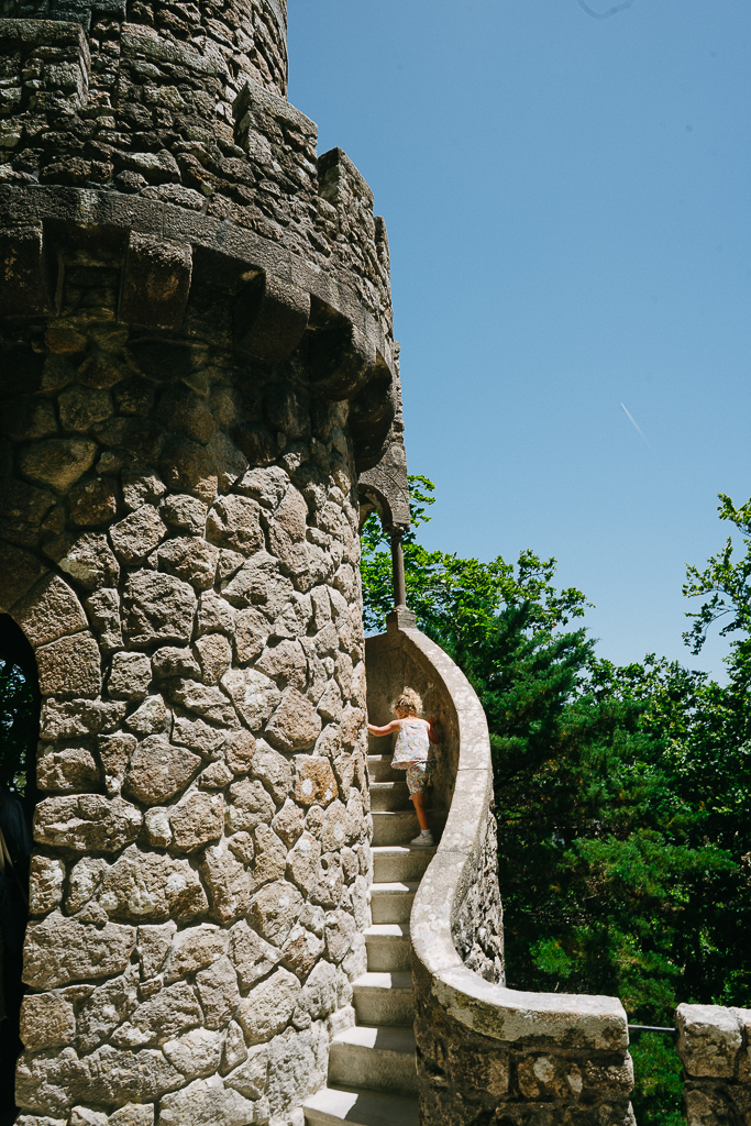 girl climbing a medieval tower in sintra portugal 