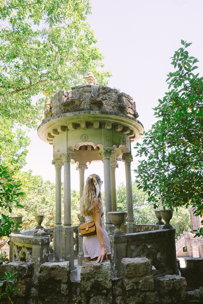 ruth nuss next to a stone well in quinta da regaleira in sintra portugal 