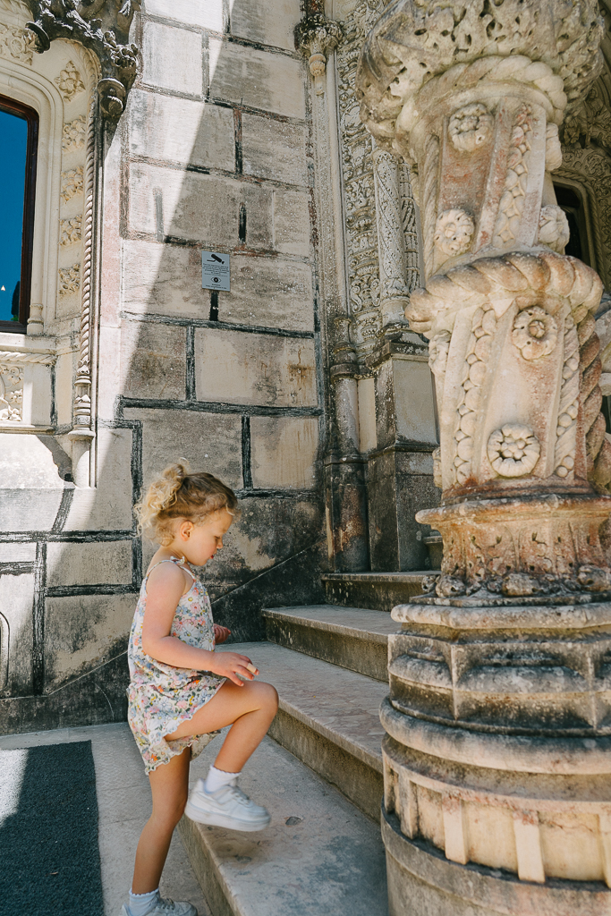 girl walking up the stairs at quinta da regaleira in sintra 