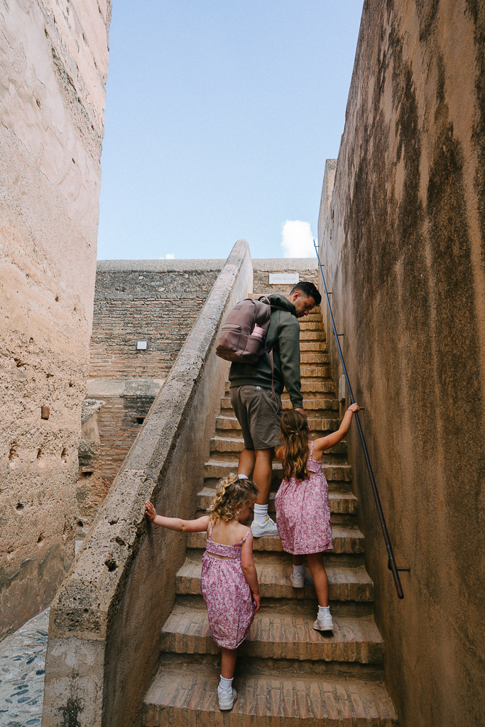 climbing the stairs at the alhambra palace in granada spain