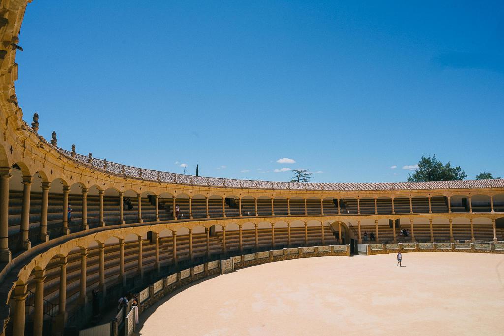 the ronda bull ring under a bright blue sky