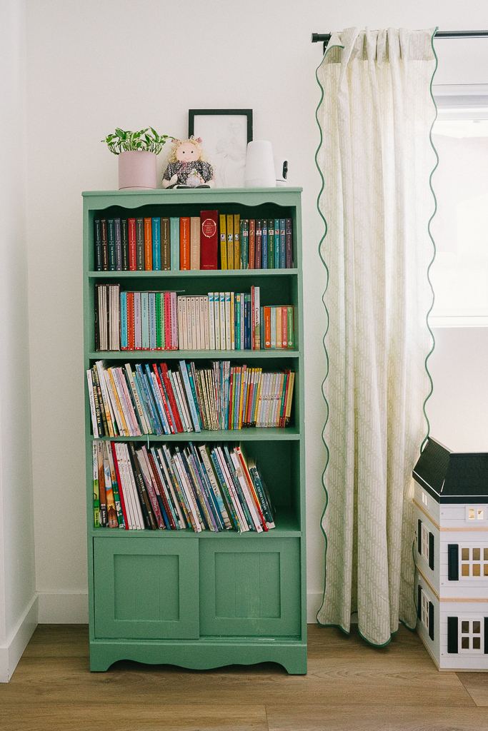 green bookshelf in a girls bedroom