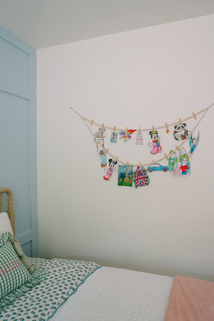 wooden beads with clothespins and kids art hanging on a wall sisters bedroom ideas