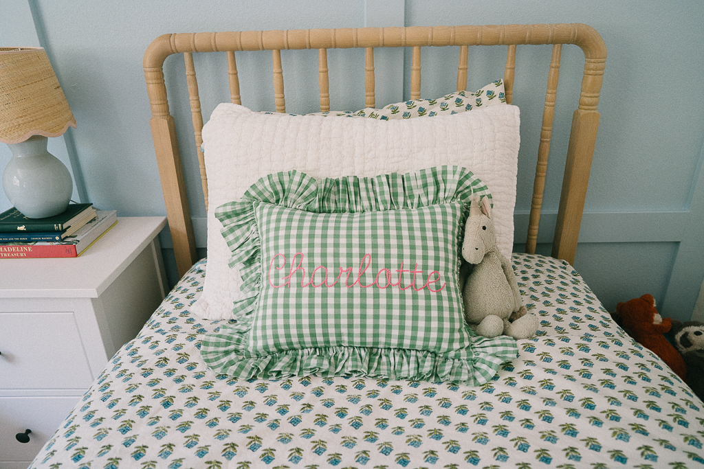 green gingham pillow with pink stitching 