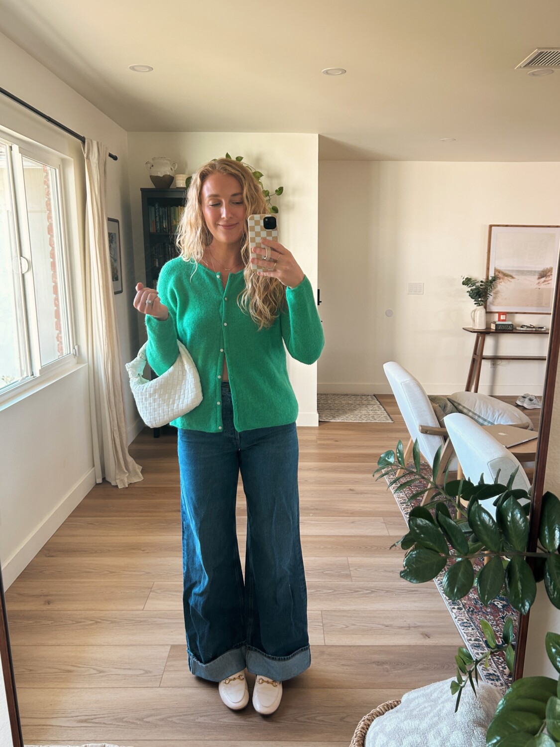 ruth nuss wearing wide leg cuffed jeans with a sezane gaspard sweater