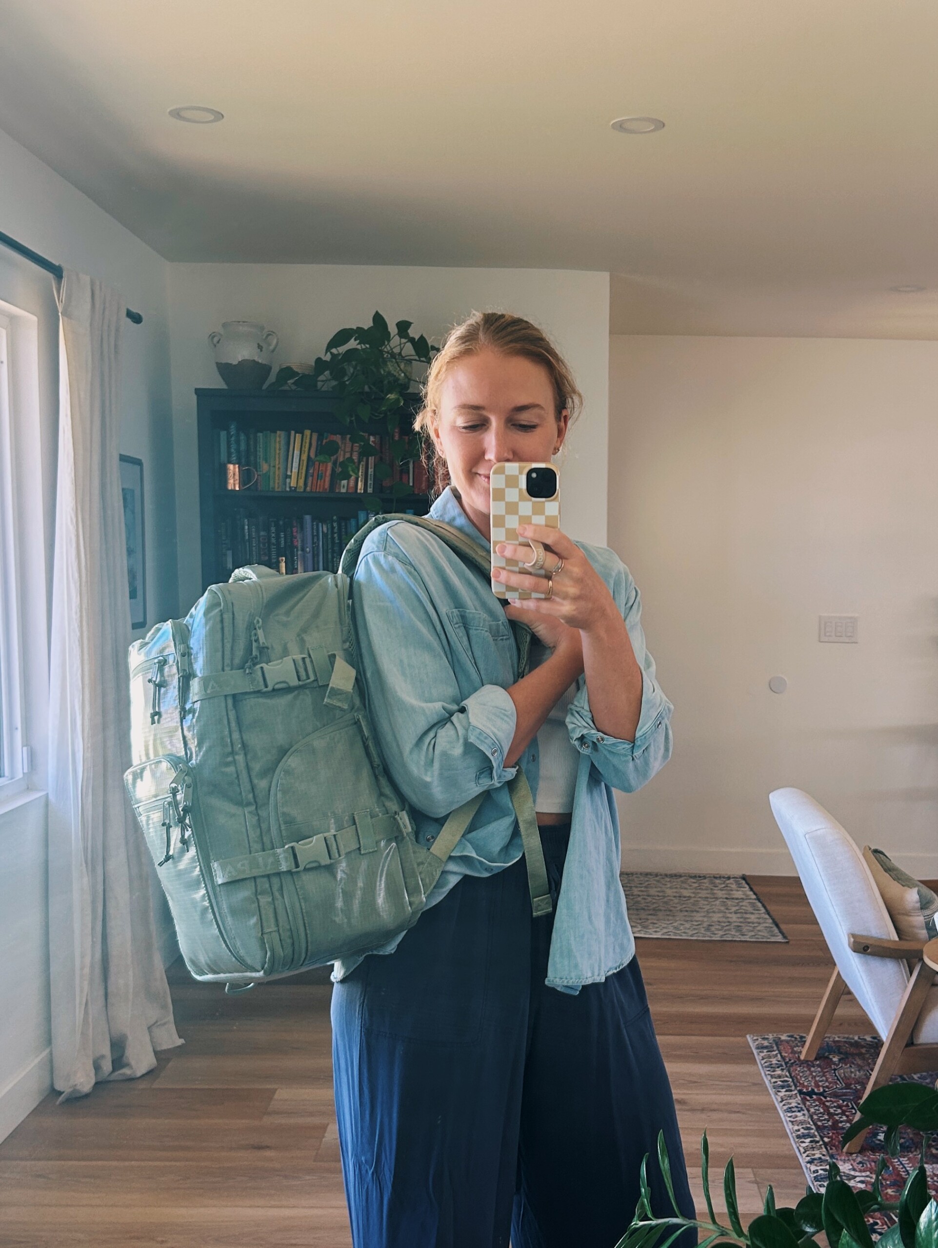 ruth nuss holding her calpak terra backpack