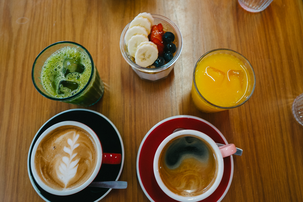 two coffees, green juice, yogurt, and orange juice in porto portugal