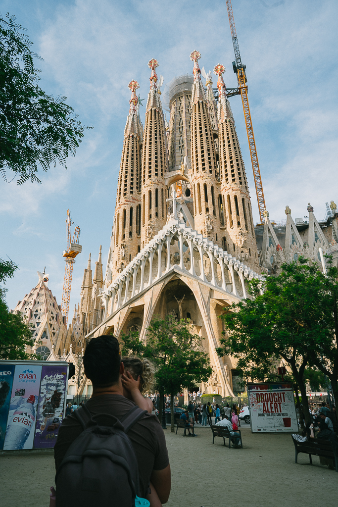 man holding his daughter in front of la sagrada familia in a 1 day barcelona itinerary