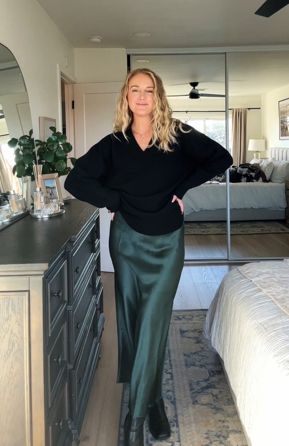 ruth nuss wearing a black cashmere sweater from quince and a quince silk skirt