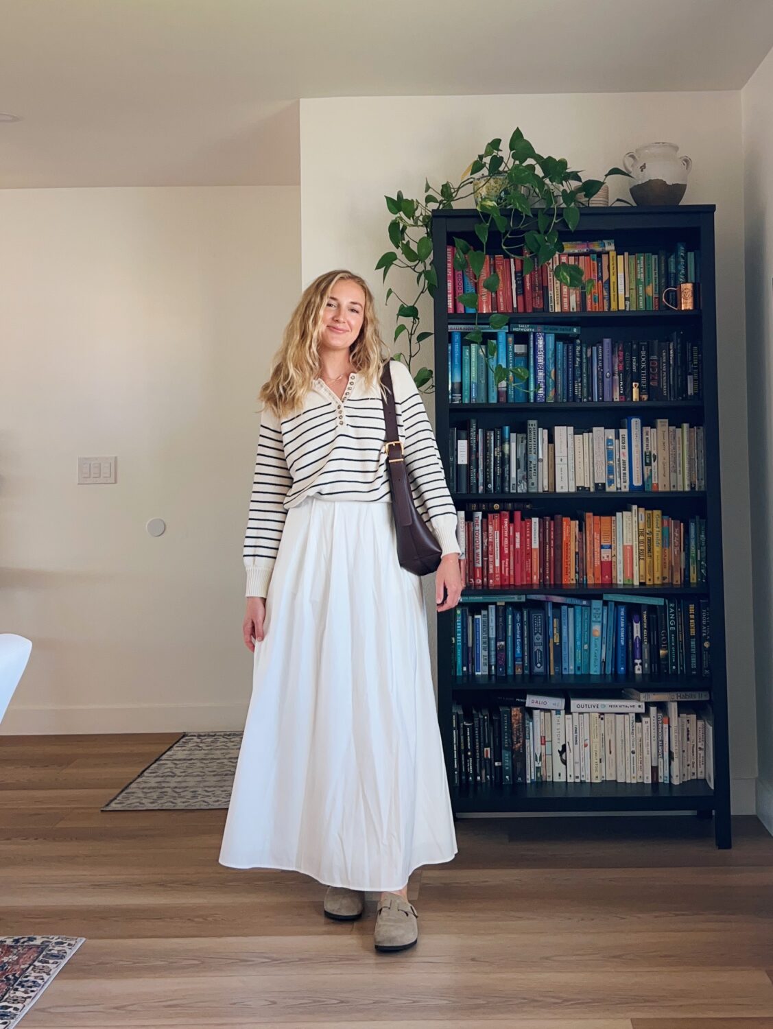 ruth nuss wearing a sezane sweater and a white maxi skirt.