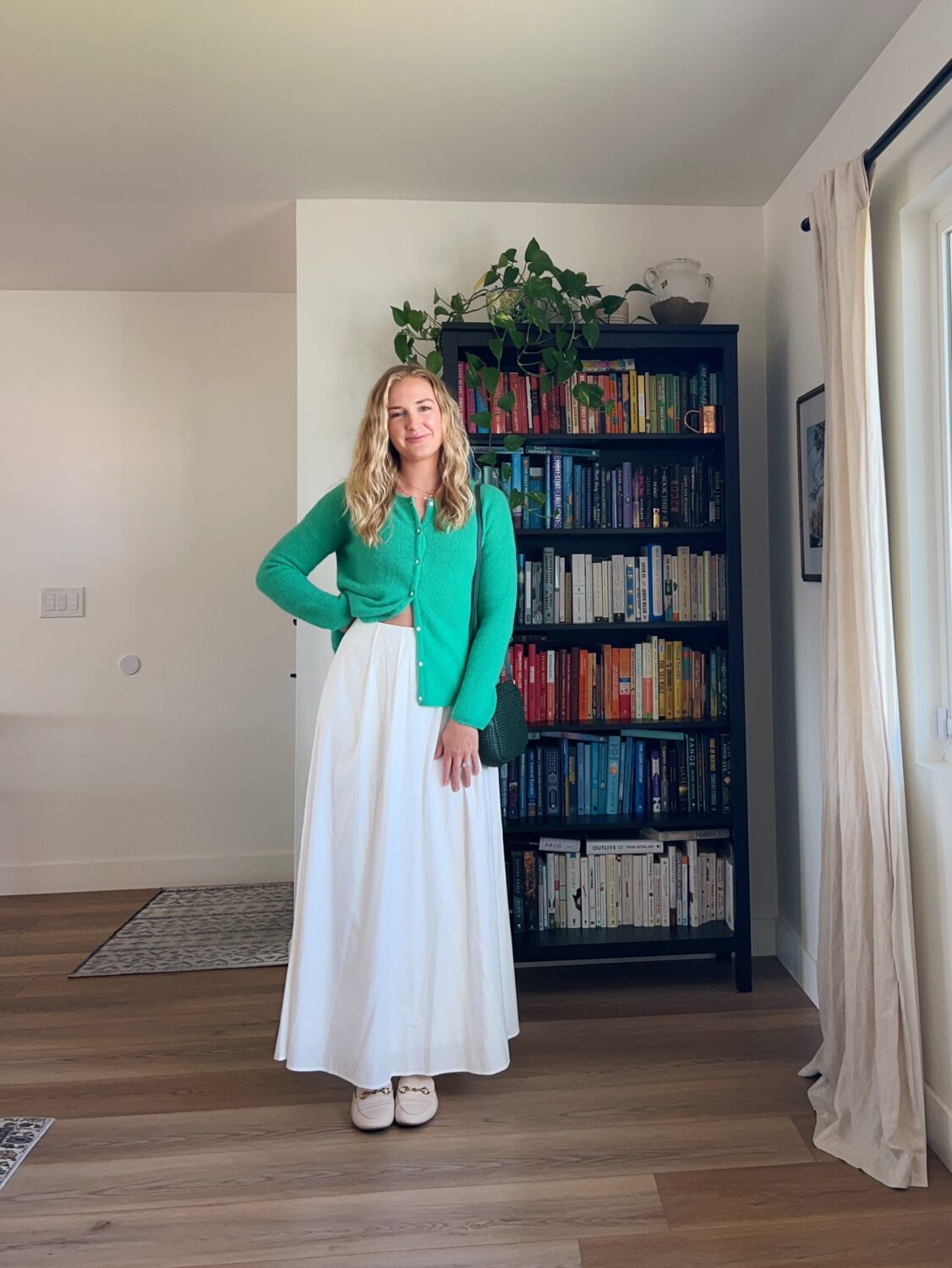 ruth nuss wearing a sezane gaspard cardigan and her reformation lucy skirt