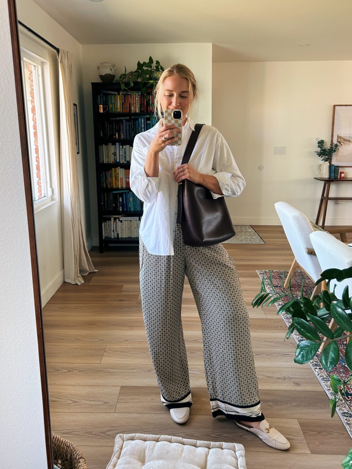 ruth nuss wearing a white button down shirt with her madewell essential bucket tote