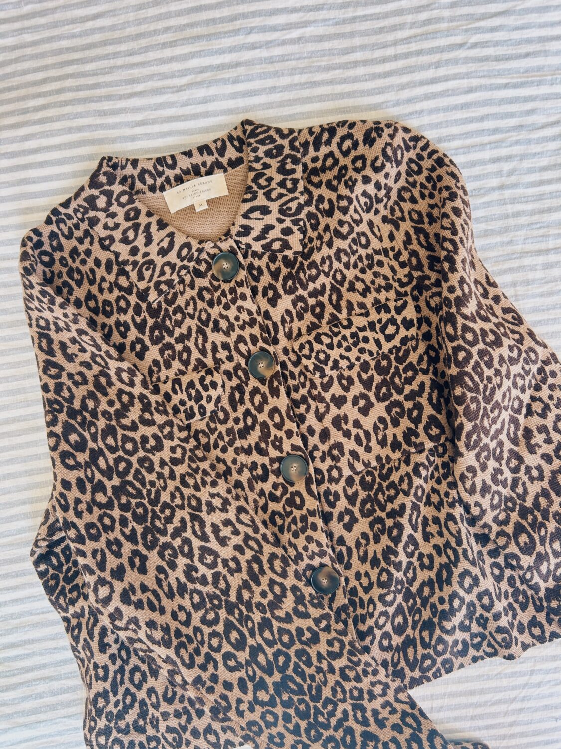 leopard print sezane sweater on a bed for a sezane betty cardigan review