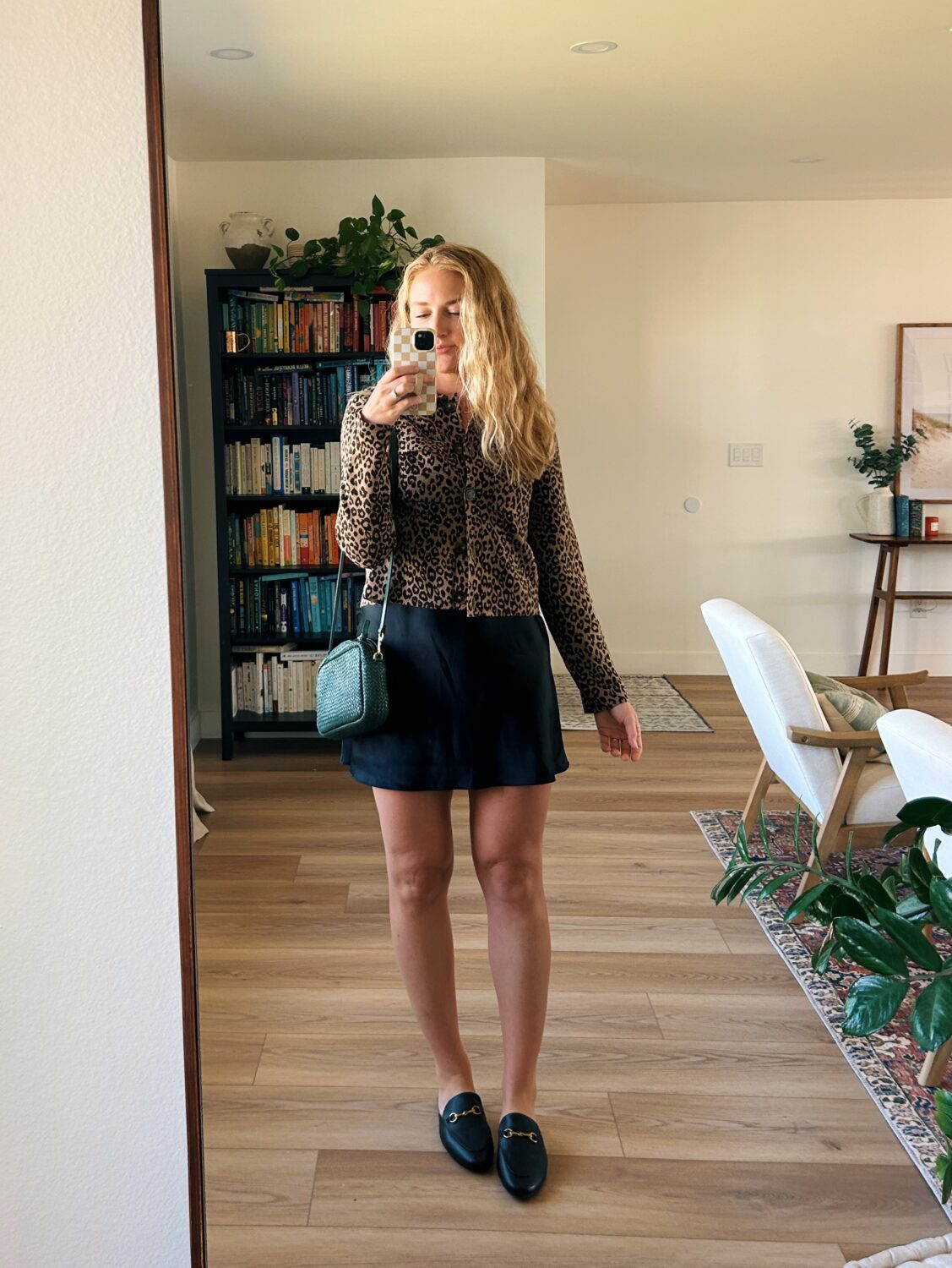 ruth nuss wearing a black skirt with her sezane betty cardigan