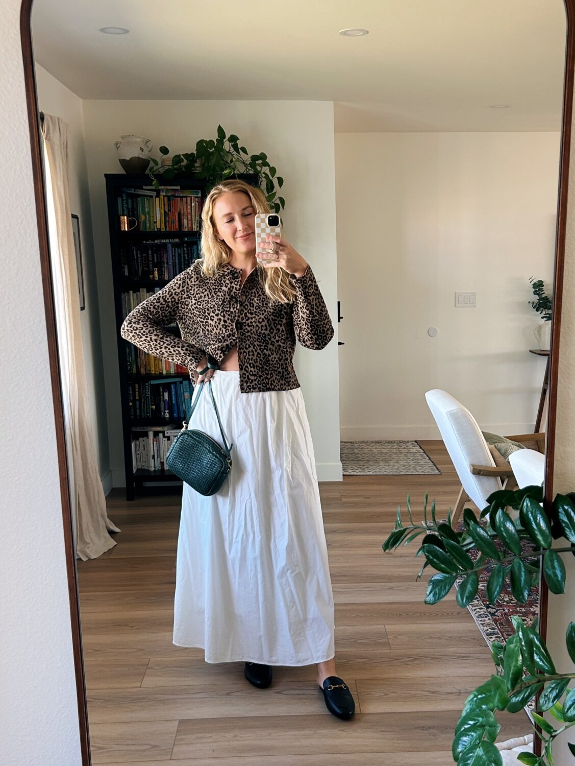 ruth nuss wearing the sezane betty cardigan and a white skirt