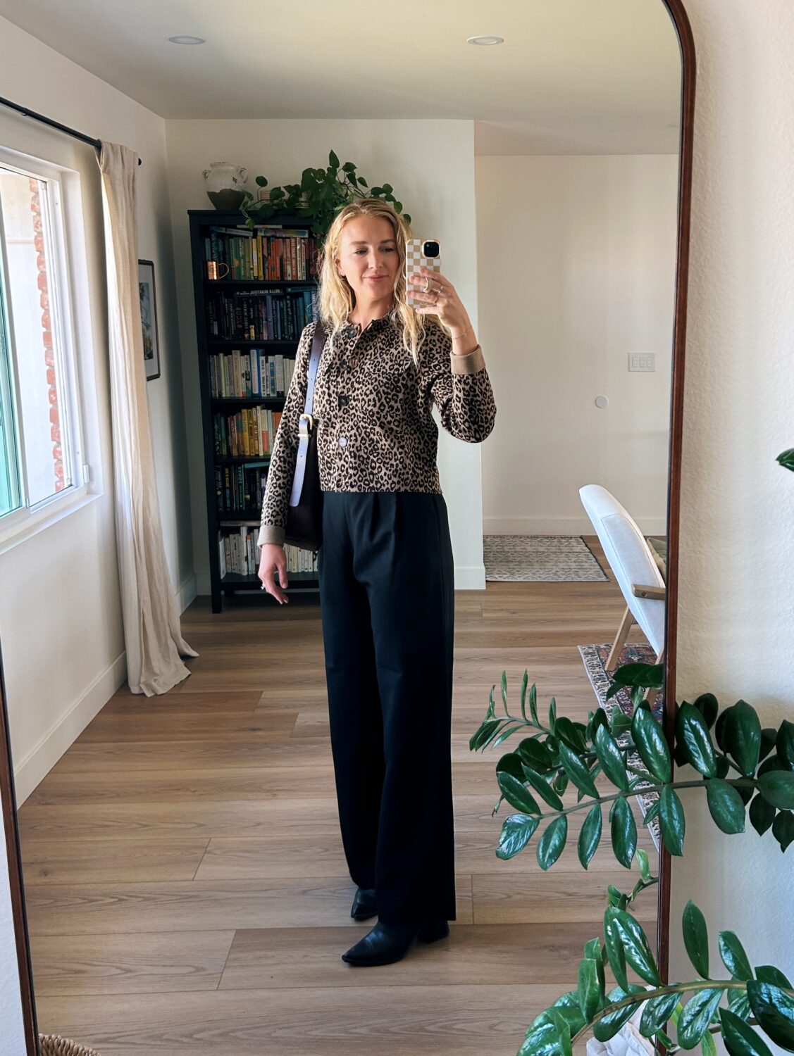 ruth nuss wearing black trousers and the sezane betty cardigan