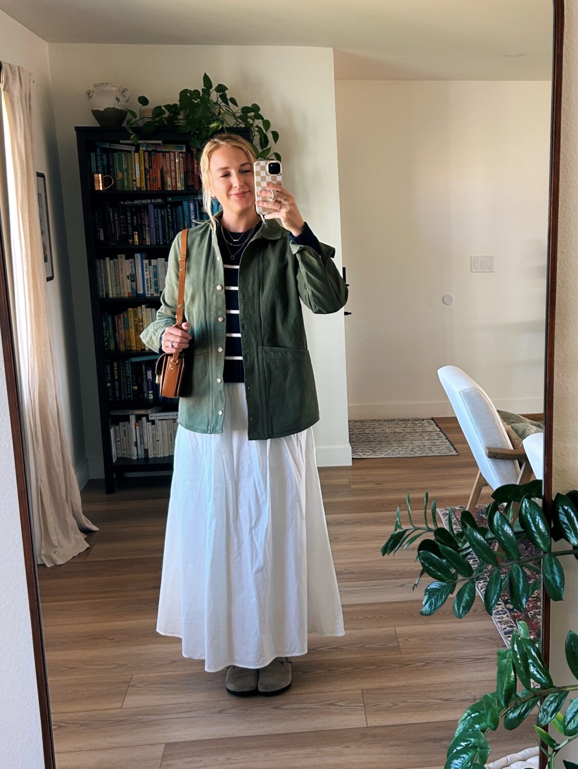 ruth nuss wearing a white skirt and a green jacket