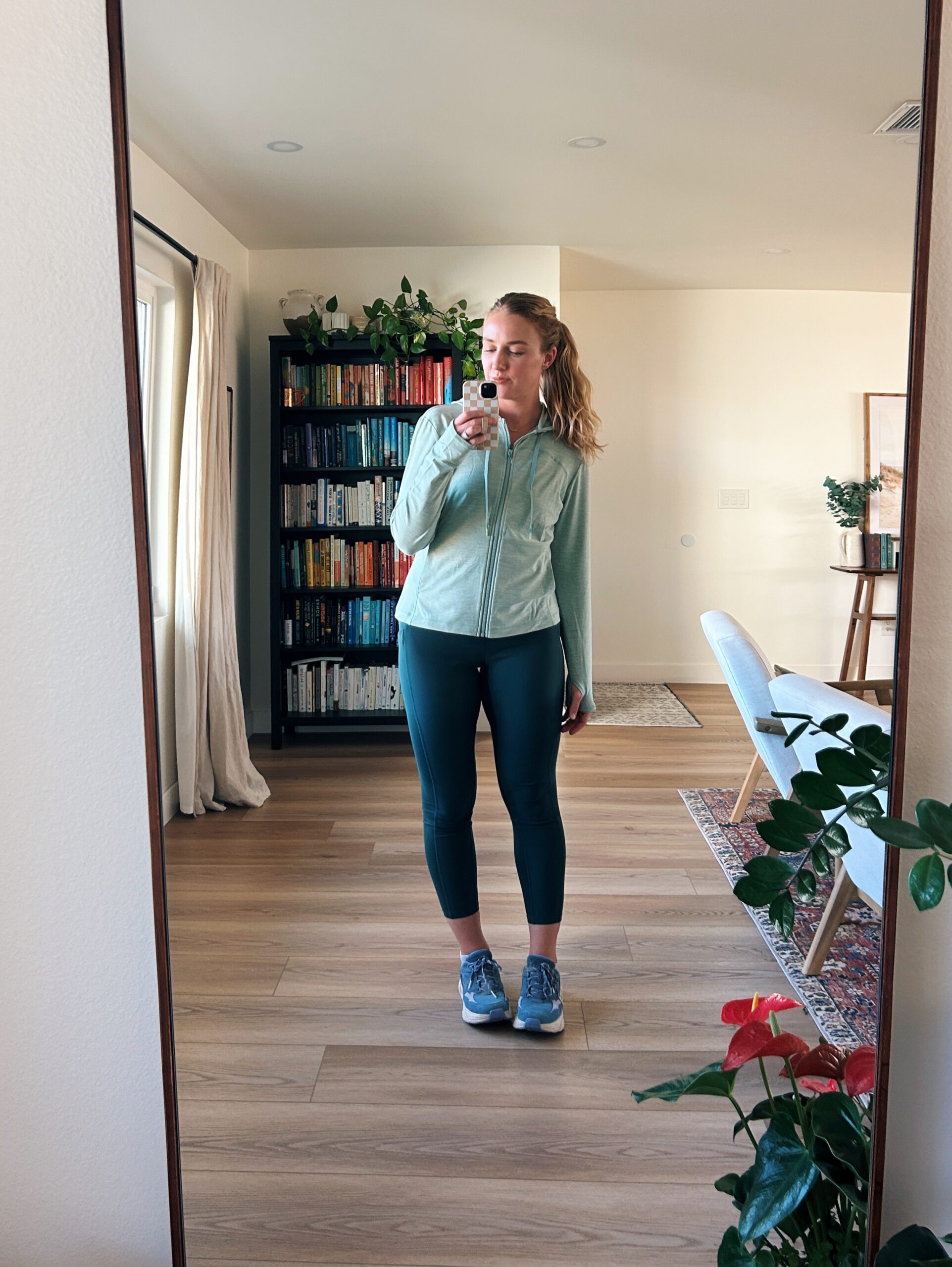 ruth nuss wearing a green jacket and hiking leggings for her title nine clothing review