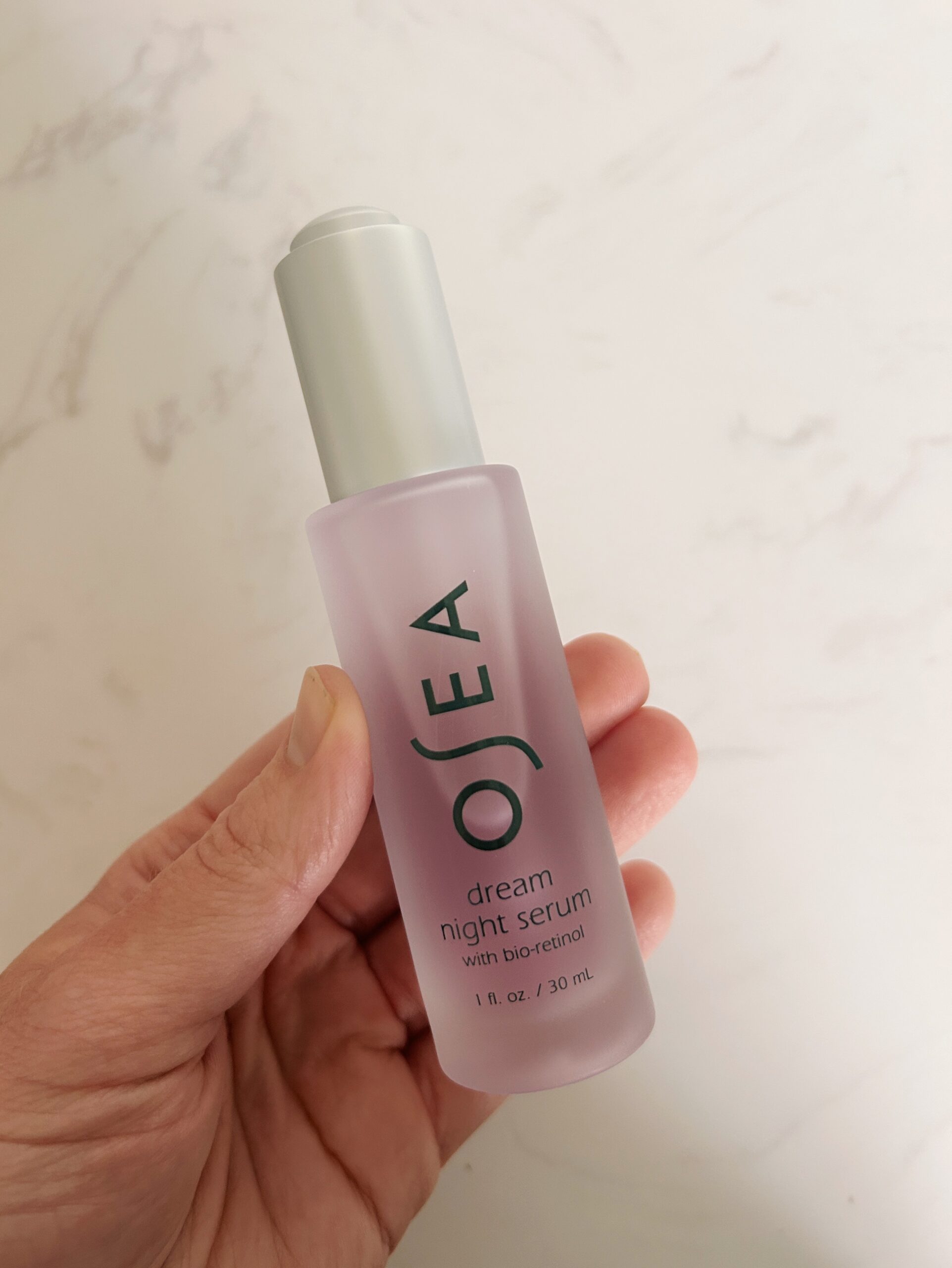 hand holding OSEA's dream night serum for an OSEA review