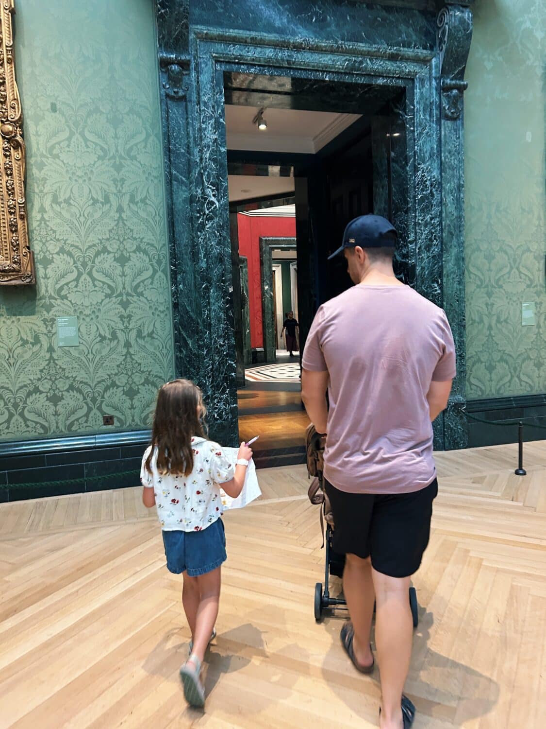 tyler nuss and his daughter walking in the national gallery. london with kids