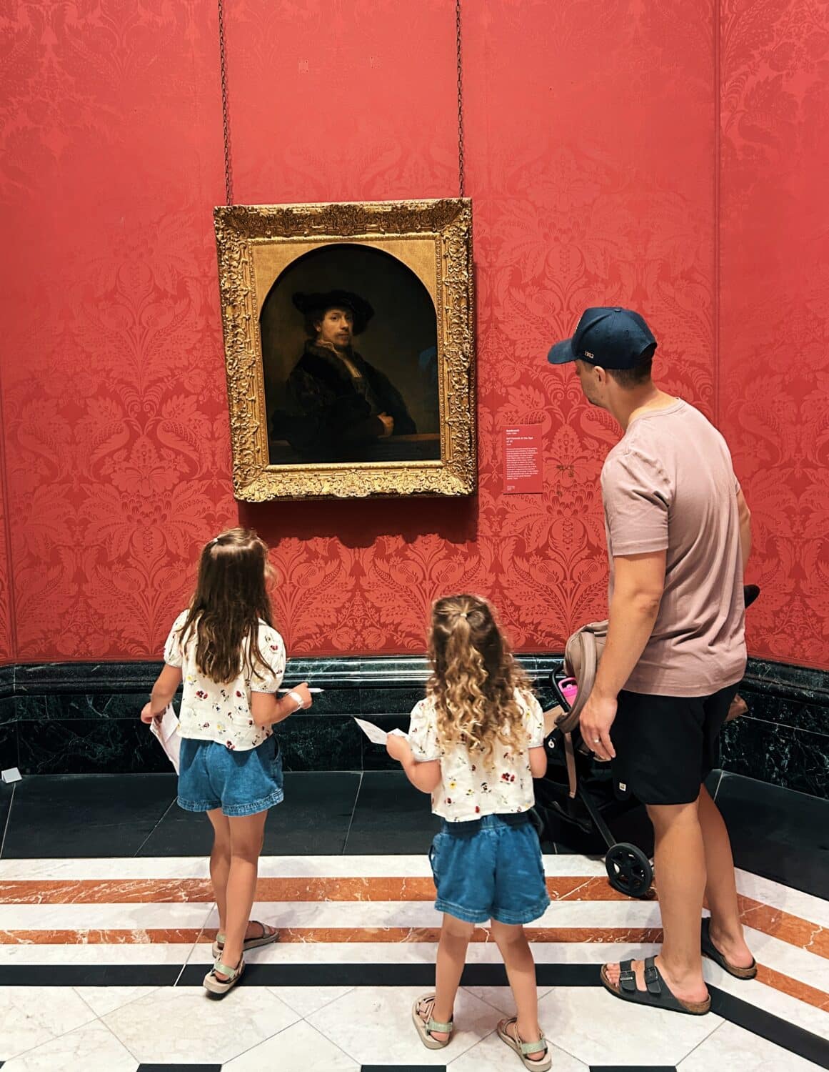 tyler nuss and his daughters looking at a rembrandt painting in the national gallery on a guide for london with kids