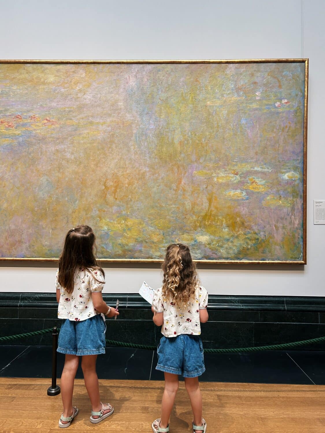 two children looking at a claude money painting in the national gallery in london